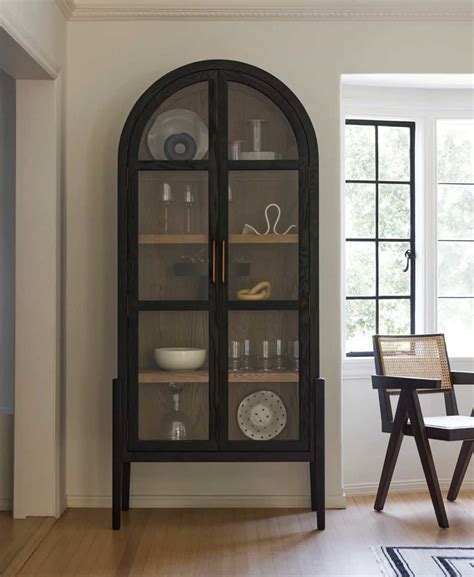 black steel and glass cabinet|black arched cabinet with doors.